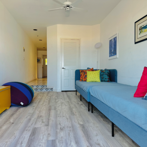 - Bright pops of color & soft textures make this room perfect for lounging or extra guests
- Twin daybeds double as cozy reading spots or a playful hideaway for kids
- Laid back space to nap, stream or simply spread out & recharge between beach adventures