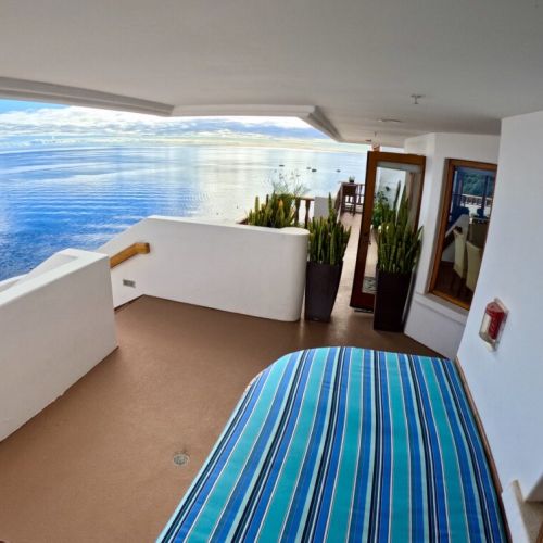 - Wake up to calm waves and sea kissed skies from this open air terrace daybed
- Surrounded by elegant potted plants and glass doors that invite in the ocean light
- Dreamy space to sip your morning coffee or stargaze at night
