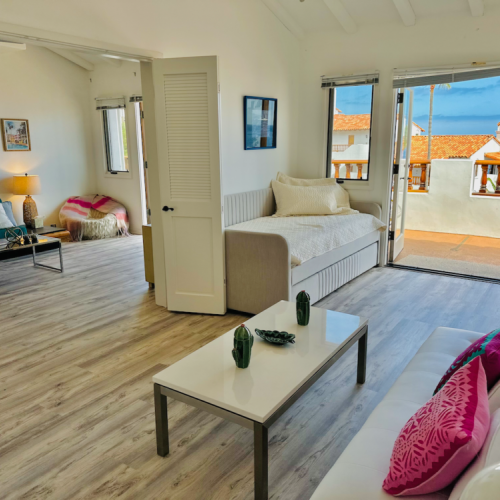 - Beautifully connected, this space blends relaxation with ocean facing charm
- Daybed offers a dreamy spot for reading or an extra place to sleep under a sea breeze
- With doors flung wide to the terrace, indoor lounging feels as fresh as being outside