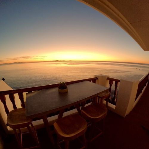 - Watch breathtaking sunsets paint the horizon with golden hues from your private balcony
- Gather around the rustic wooden bar table for memorable outdoor dining experiences
- Tranquil ocean views and cozy ambiance perfect for relaxing evenings