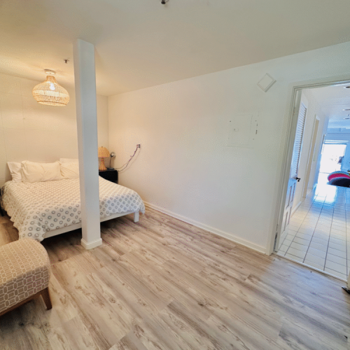 - Tucked away from the main living space, this bedroom offers privacy and total quiet
- Thoughtful touches, from wicker lamps to soft patterns, set a peaceful tone
- Restful escape after sun filled days, just steps from the heart of the home